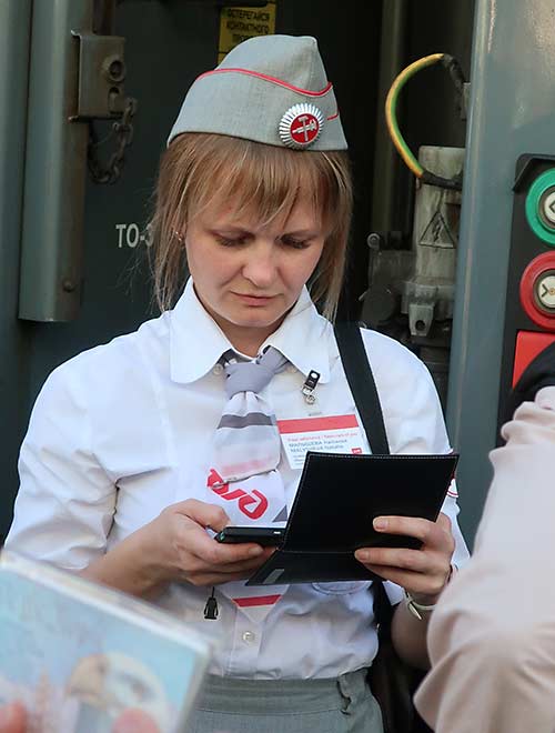 Trans-Siberian provodnita checks a boarding pass